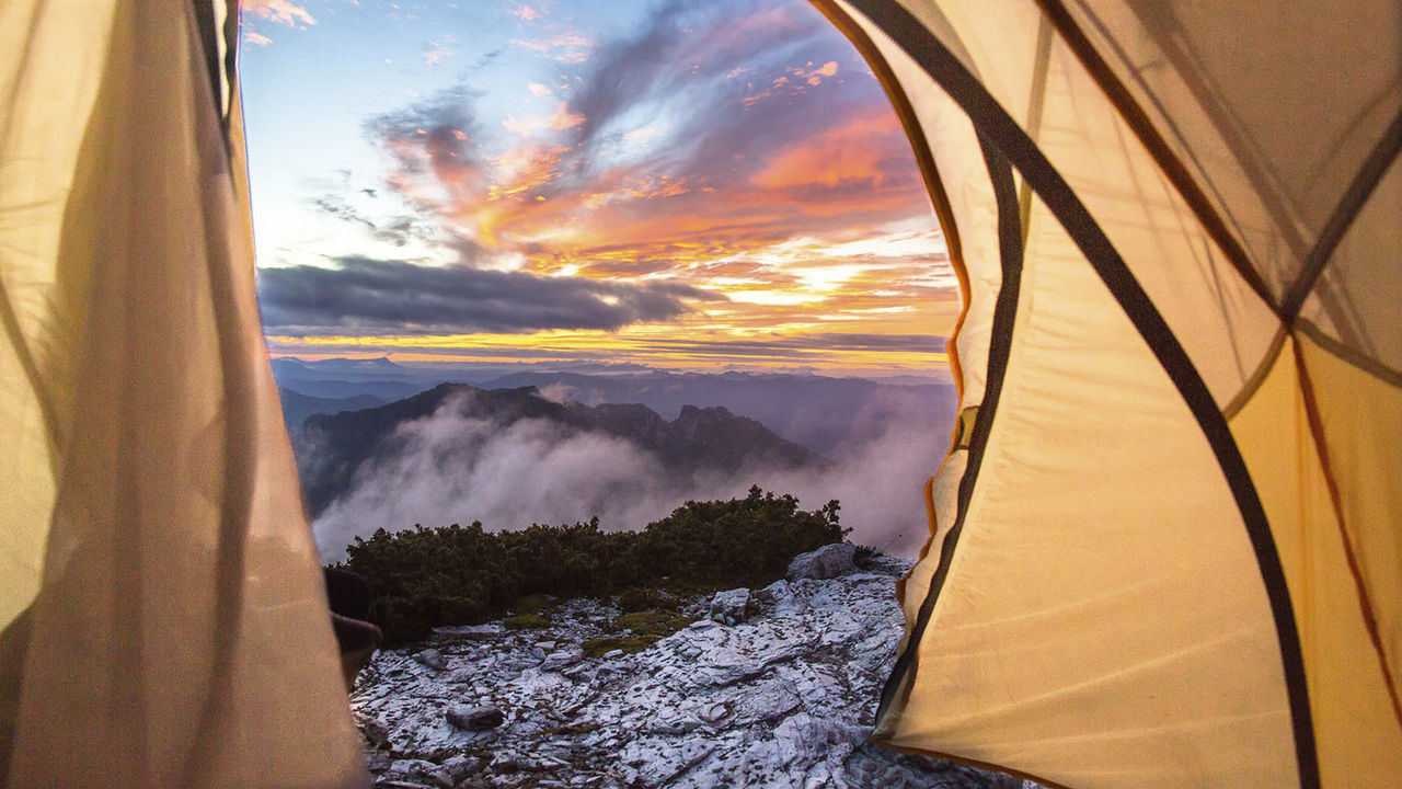 Sky at moody dawn visible from inside of tent pitched on top of Frenchman's Cap in Franklin-Gordon Wild Rivers National Park, Tasmania, Australia